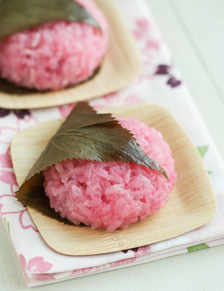 two small pink cookies with leaves on top