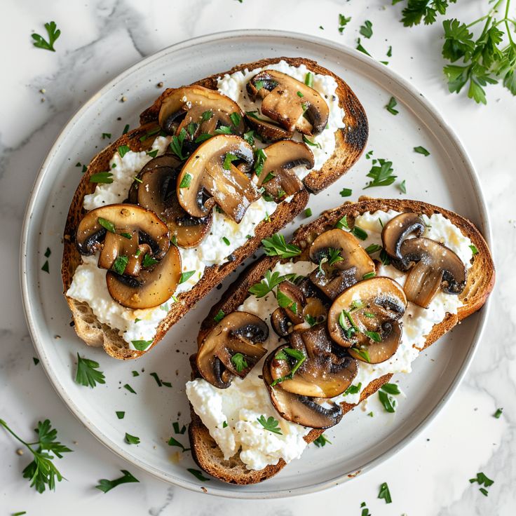 two slices of toast with mushrooms and cottage cheese on top, sitting on a plate