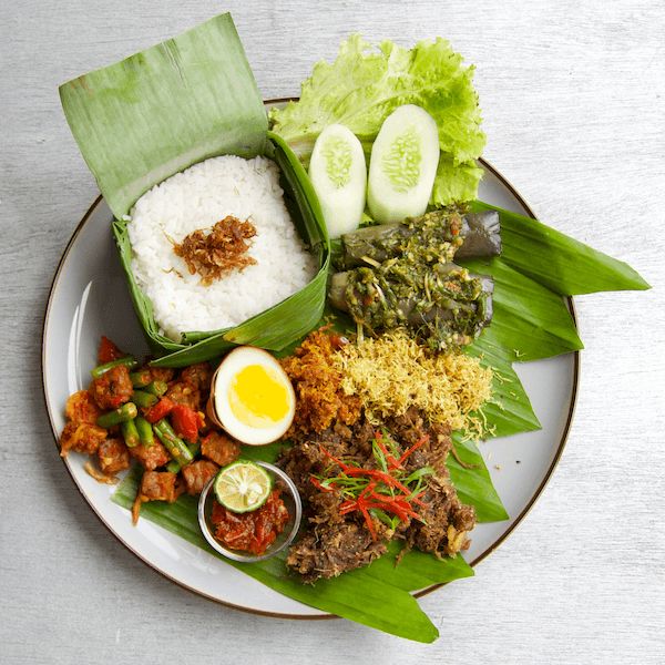 a plate with rice, meat and vegetables on it