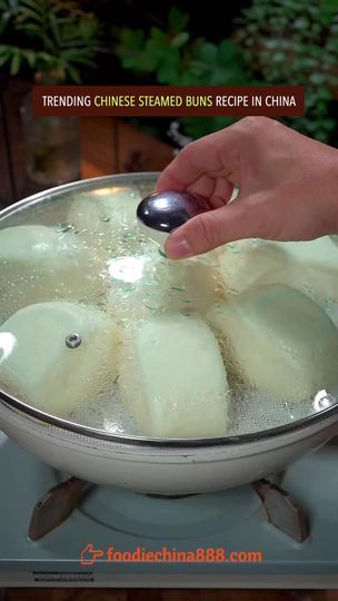 a person is using a spoon to stir food in a wok on the stove