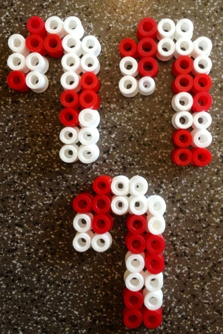 the letters are made out of legos and have white and red circles on them