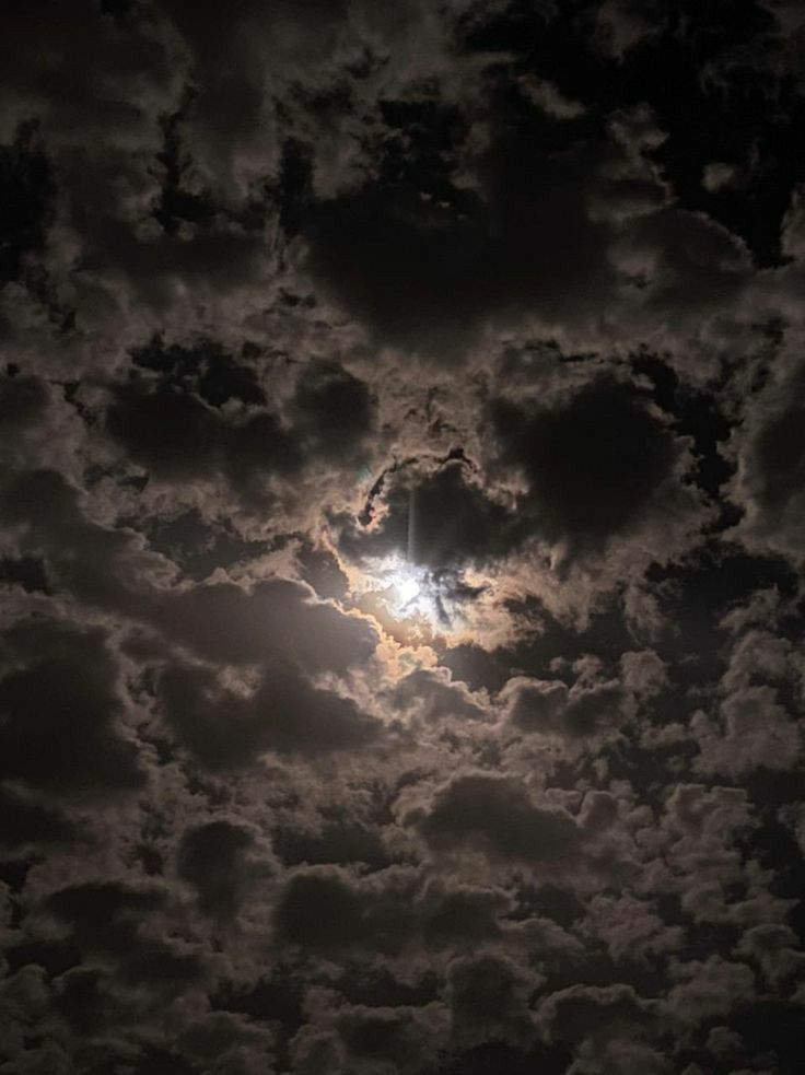 the sun is shining through some clouds in the night sky with no one on it