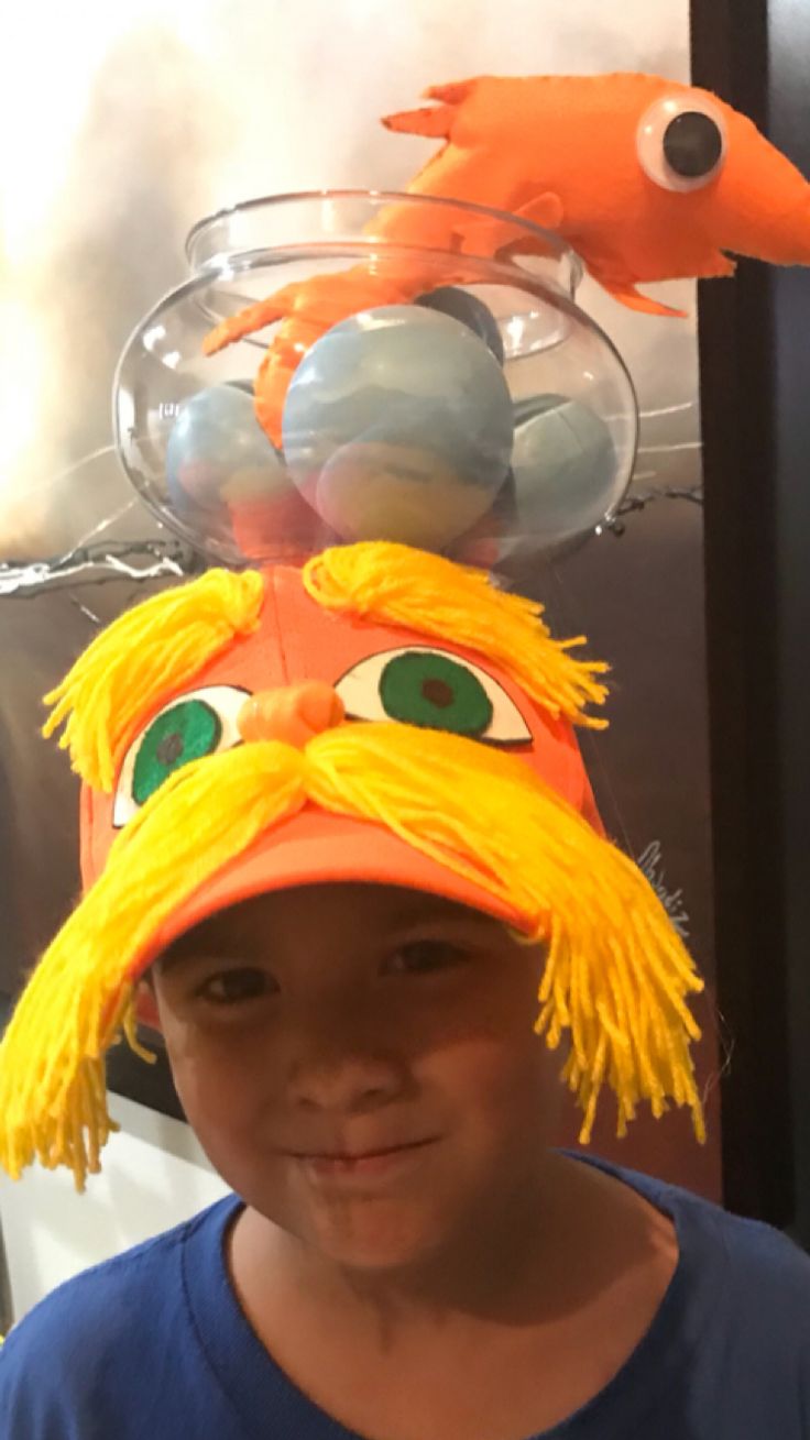 a young boy wearing a hat made to look like a fish