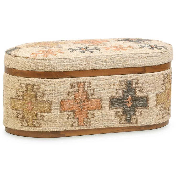 an old rug covered box sitting on top of a white floor