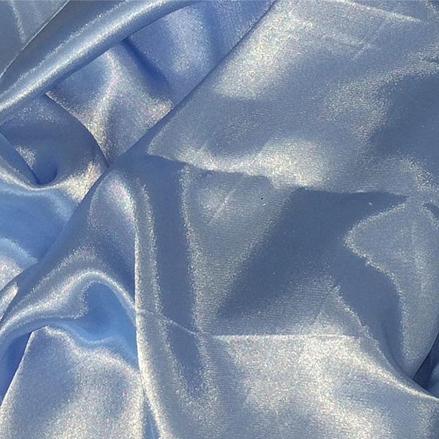 the fabric is shiny and blue in color