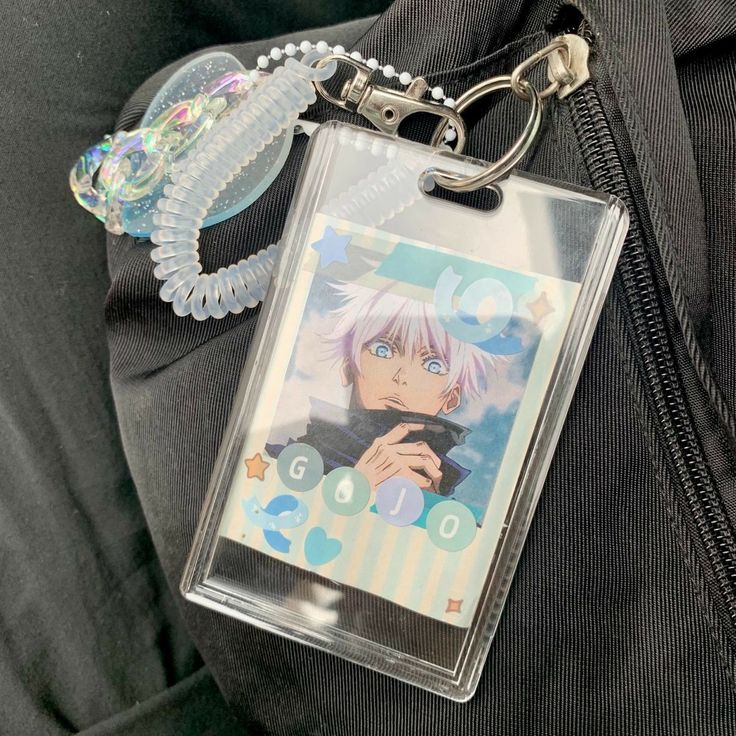 a clear plastic keychain with an anime character on it's back pocket