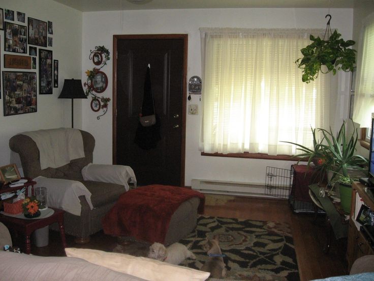 a living room filled with furniture and pictures on the wall