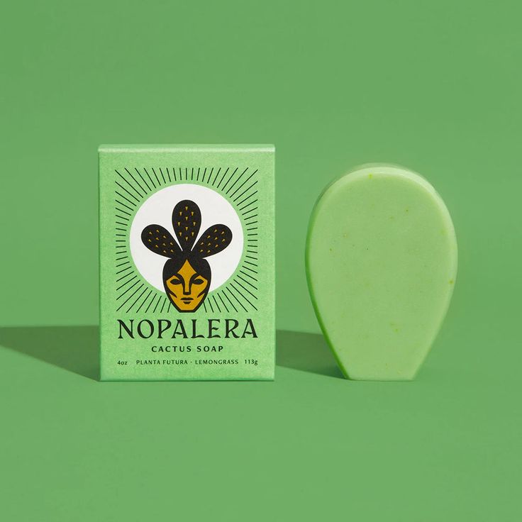 a soap bar sitting on top of a green surface next to a white and black object