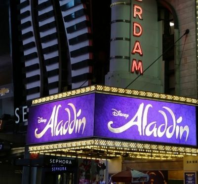 the marquee for the broadway theatre is lit up in purple and white letters