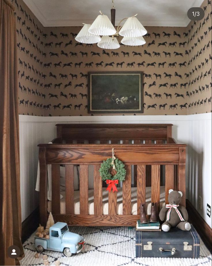 a baby's room with a crib, toy cars and a painting on the wall