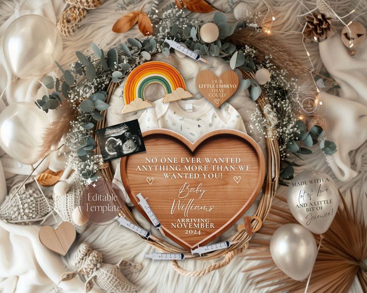 a wooden heart surrounded by white and green decorations, with a rainbow in the middle