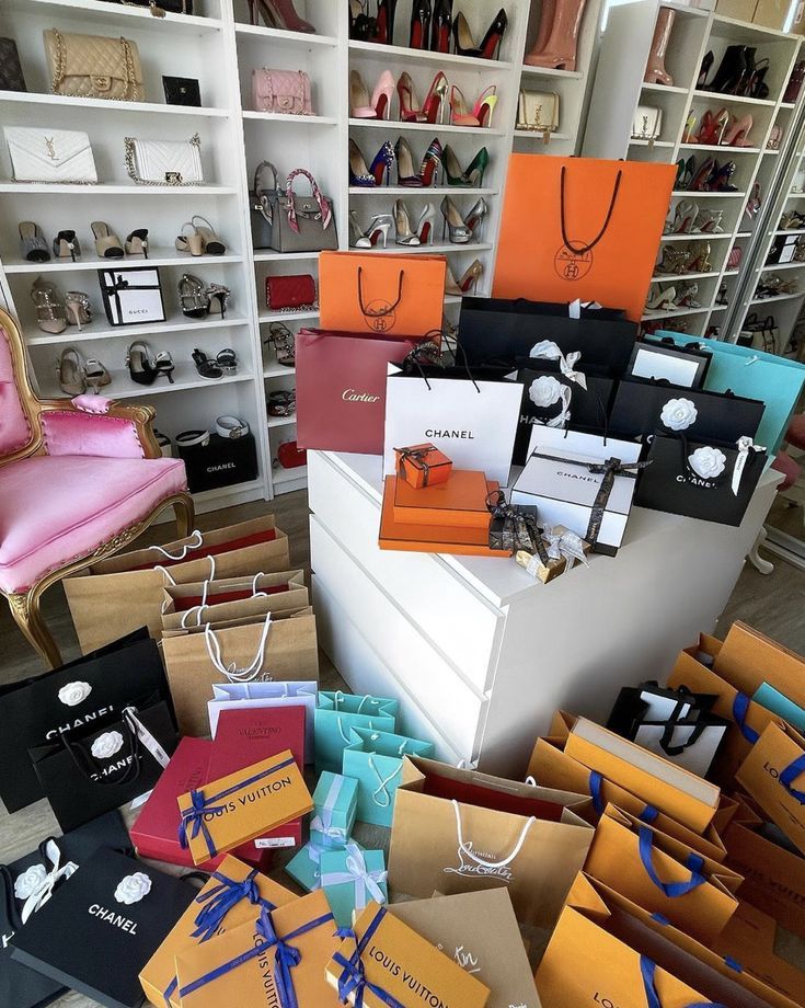 many different colored boxes are stacked on top of each other in front of a white bookcase