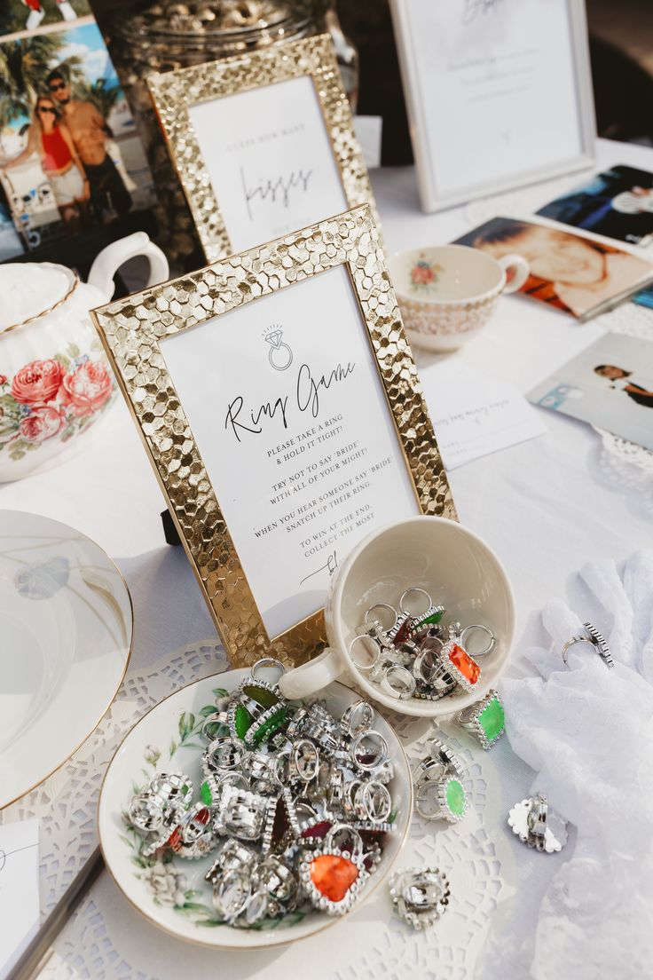 a table topped with plates and bowls filled with candies next to a framed sign