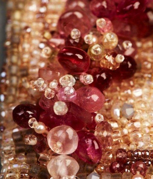 many different colored stones and beads on a table