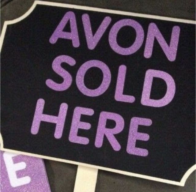 a black and purple sign with the words avan sold here written in pink on it