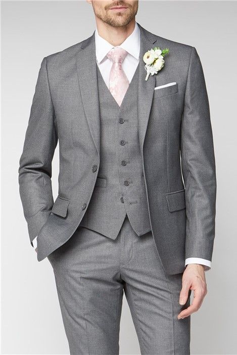 a man in a gray suit with a pink tie and flower boutonniere