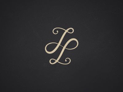 the letter j is made up of swirls and scrolls in gold on black paper