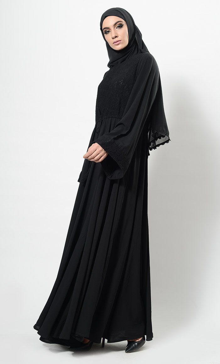 Featuring a beautiful modest wear flared abaya dress in nida basie adorned with self woven floral lace panel covering the top of the bodice and edges of bell style loose sleeves. It has drawstring detailing around the waist and is comfortable to be worn both for informal and formal ocassions.FIT : Relaxed fit.COMPOSITION : Nida.CARE : Dry clean only. Flowy Maxi-length Abaya For Eid, Flowy Long Abaya For Eid, Elegant Flowy Abaya For Eid, Modest Flowy Maxi Length Abaya, Modest Solid Color Floor-length Abaya, Modest Floor-length Abaya, Solid Color Abaya With Modesty Panel For Eid, Elegant Maxi Length Niqab For Eid, Eid Abaya With Modesty Panel In Solid Color