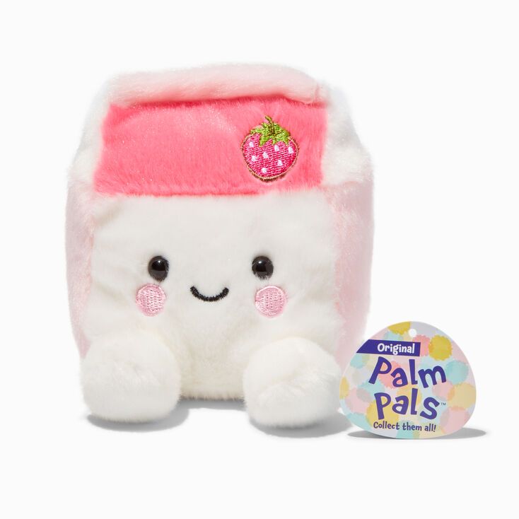 a small stuffed animal with a strawberry on it's head sitting next to a button