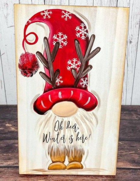 a wooden sign with an image of a santa clause