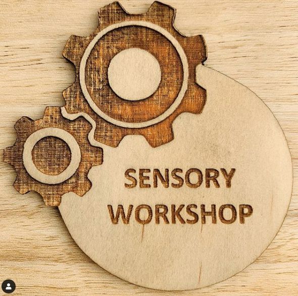 a wooden sign with the words sensory workshop on it