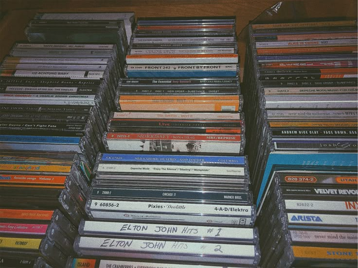 a bunch of cds that are stacked on top of each other