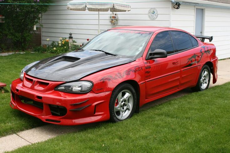 a red car parked in front of a house