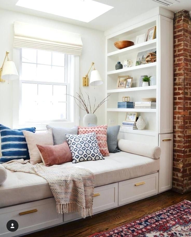 a living room filled with lots of white furniture