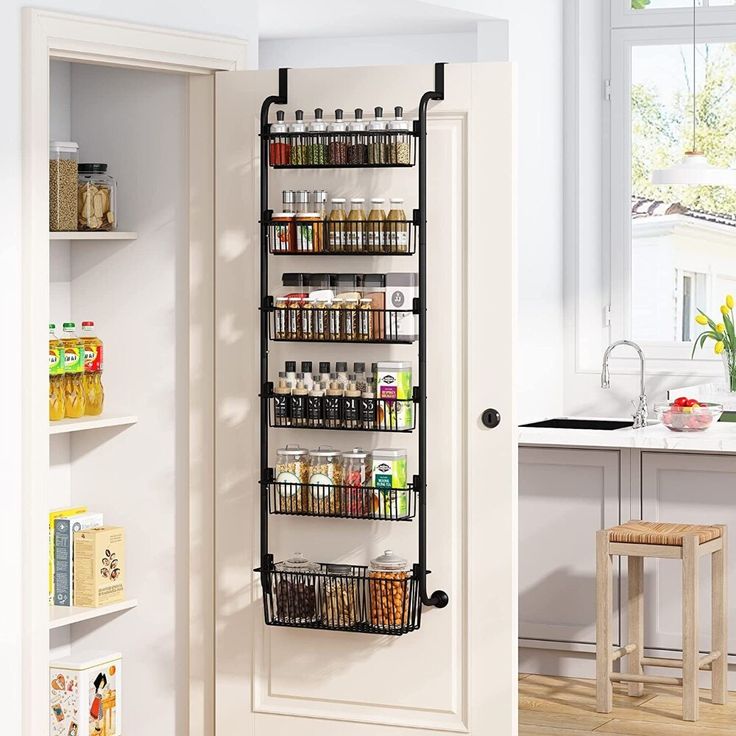 the pantry door is open to reveal an assortment of spices and condiments in it