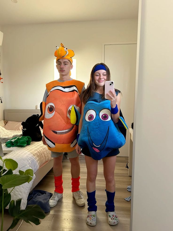 two people dressed up as finding nemo and finding dory in a hotel room