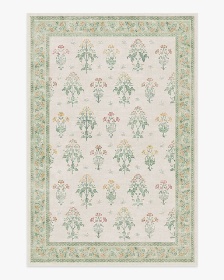 a white and green rug with flowers on the bottom, in front of a beige background