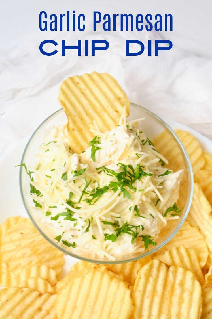 garlic parmesan chip dip in a glass bowl with crackers on the side