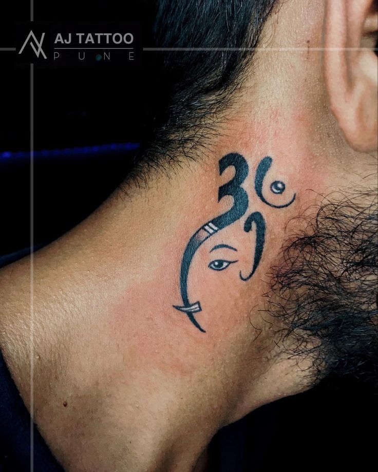 a man with a tattoo on his neck has an omen symbol behind the ear