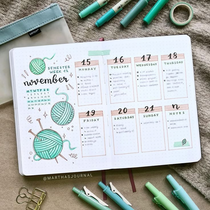 an open planner with markers, pens and scissors