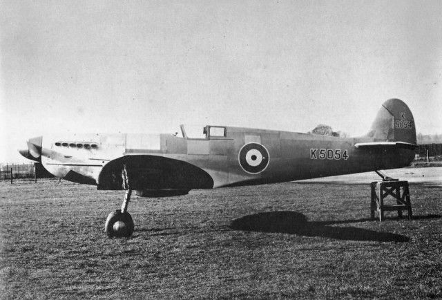 an old airplane sitting on top of a grass covered field