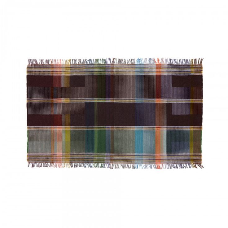 a multicolored plaid rug with fringes on the bottom and one stripe down the middle