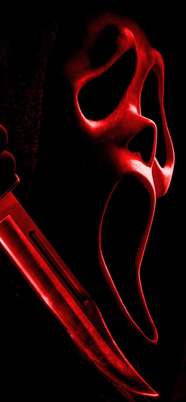 a red light shining on the side of a knife