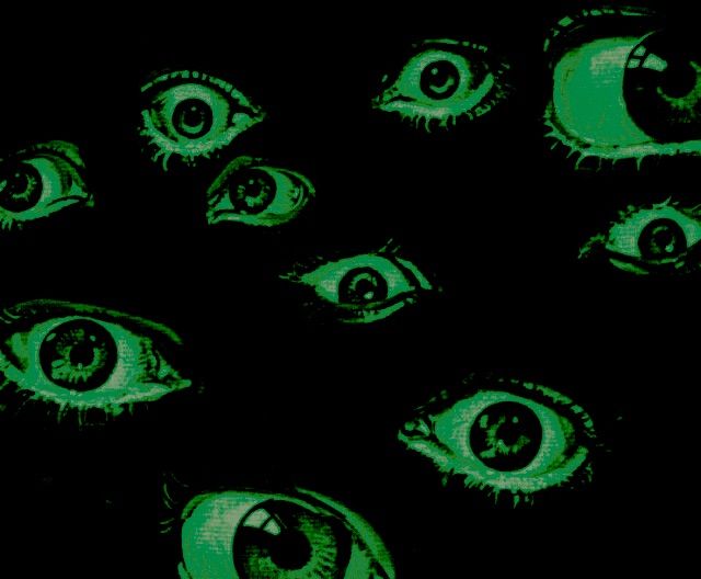 an image of green eyes in the dark