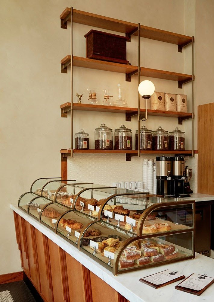 a counter with many different types of pastries on it in a store or restaurant