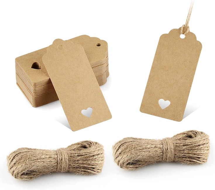 twine and tags on white background with heart cutout in middle, two small hearts at the end