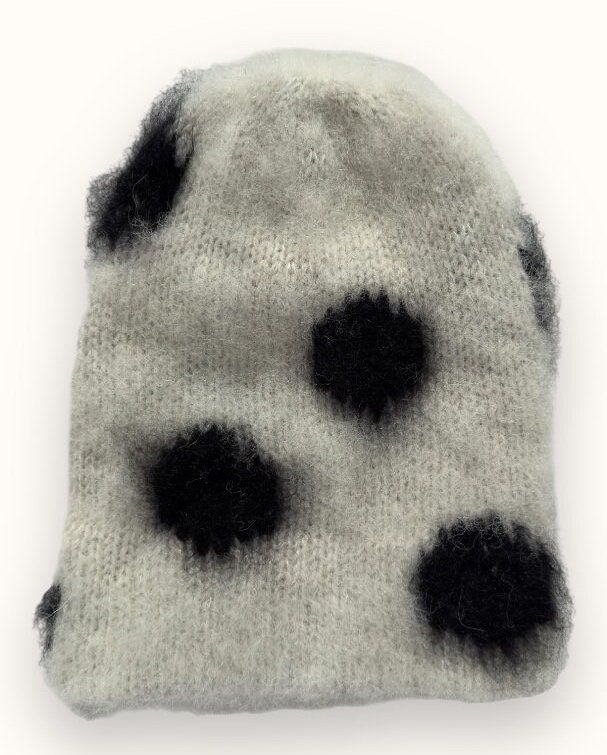 a black and white hat with spots on it