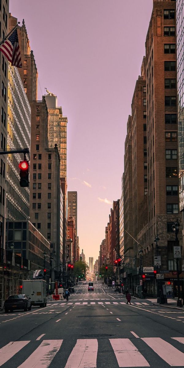 an empty city street with traffic lights and buildings