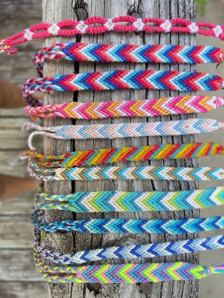 several different colored bracelets hanging from a tree