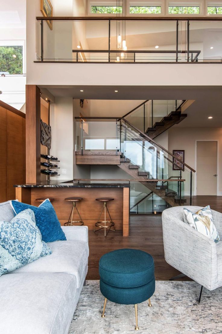 a living room filled with furniture and a stair case