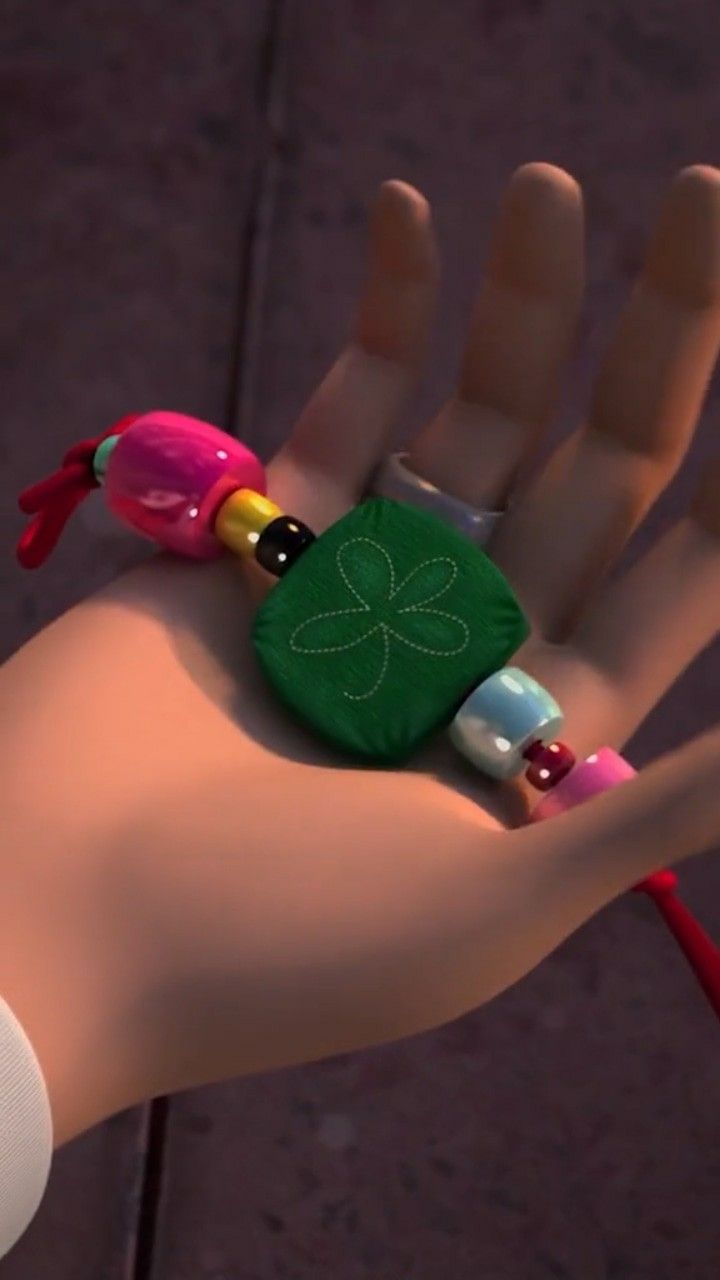 a close up of a person's hand with a bracelet on it