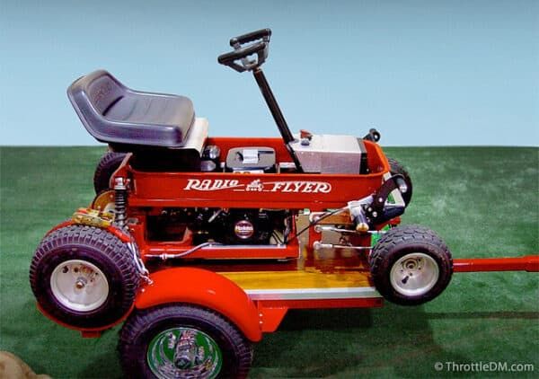 a red lawn mower sitting on top of a green field