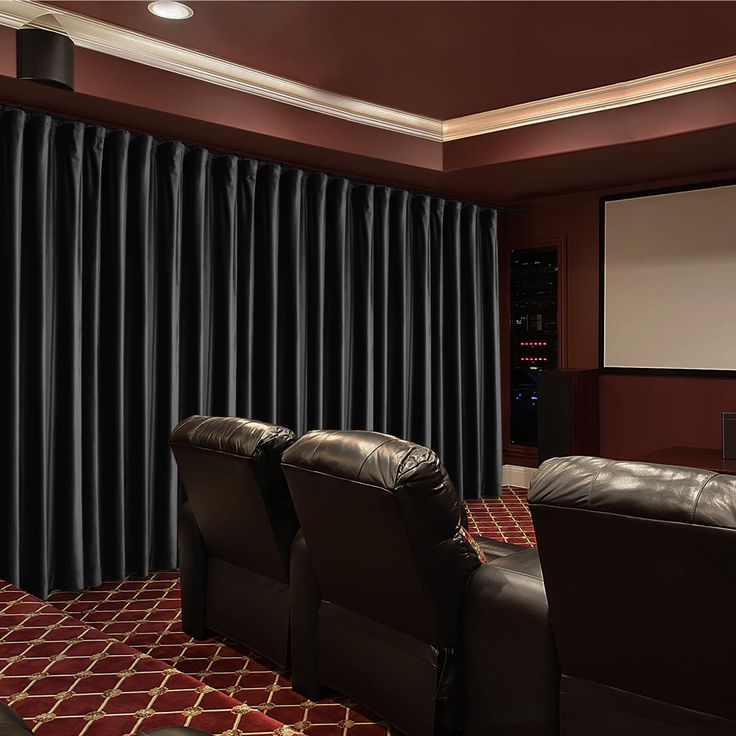 a home theater with two recliners and a projector screen