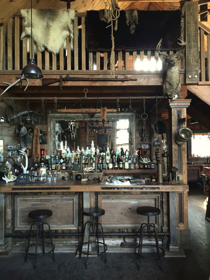 an old fashioned bar with lots of bottles on it