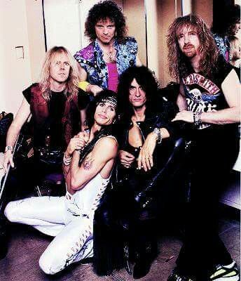 the band kiss posing for a photo in their dressing room