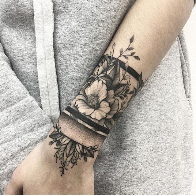 a woman's arm with flowers on it and the words love written in black ink